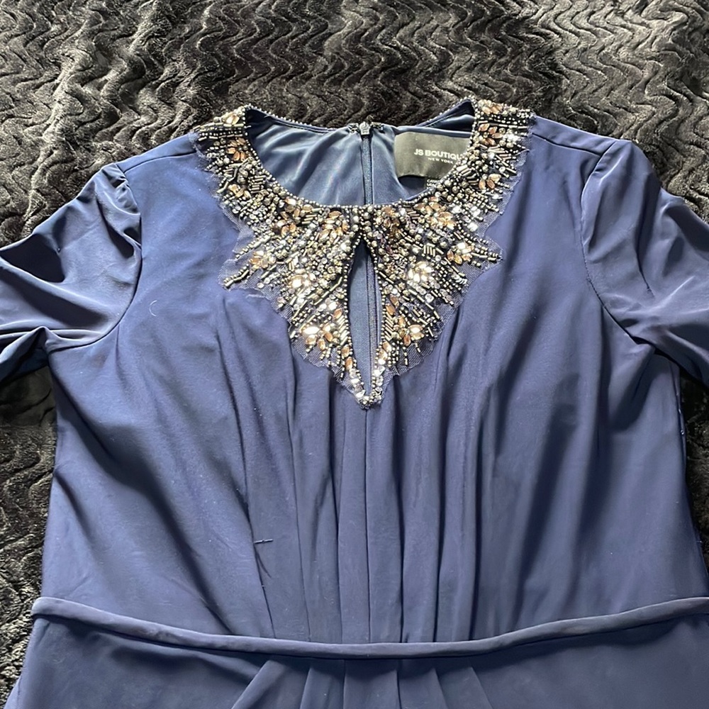 Gently used navy blue gown with beaded collar and zip closure back. Fully lined